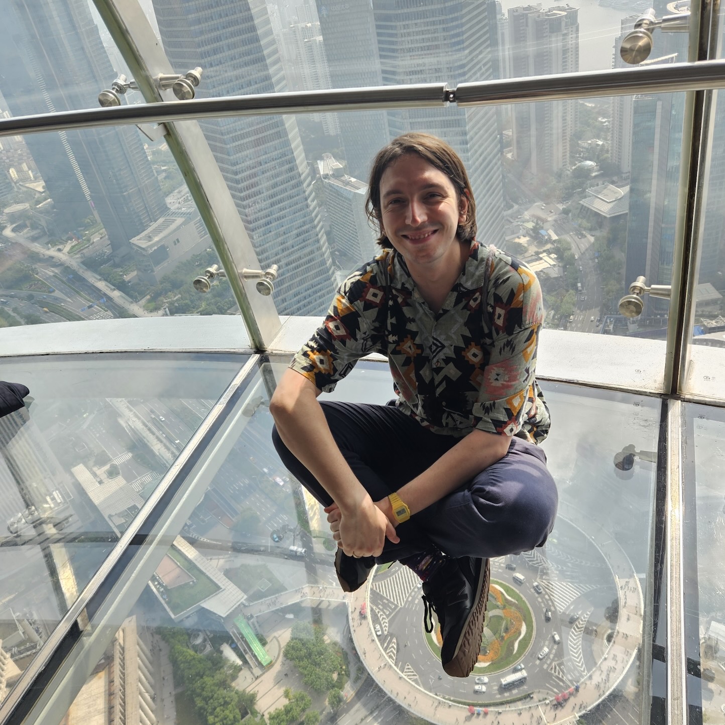 The picture of myself sitting on a glass floor in Shanghai Oriental Pearl.